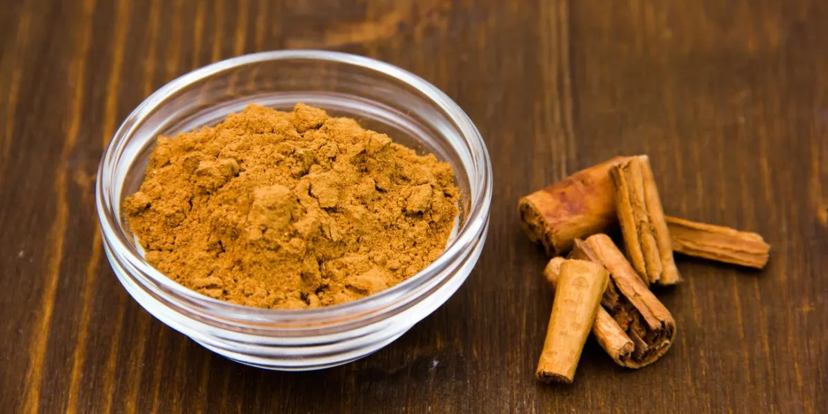 glass bowl with cinnamon on wooden table