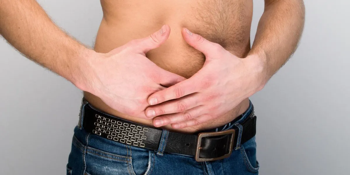 closeup on man's stomach in pain