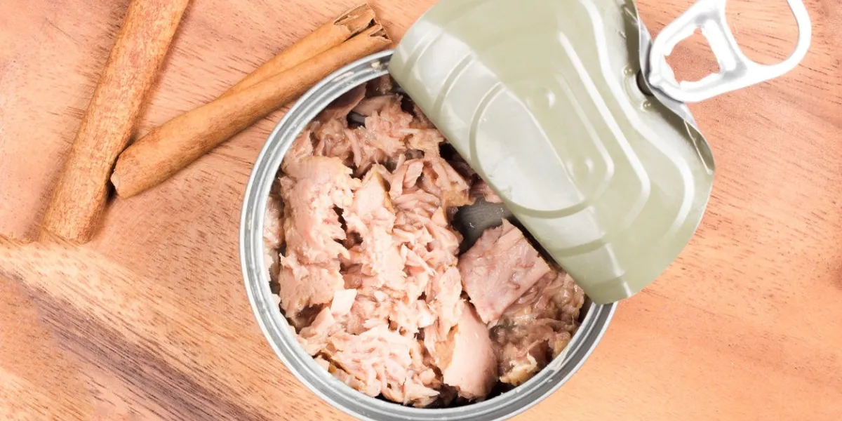 tuna in can on wood plate on wooden background tuna fish food top view