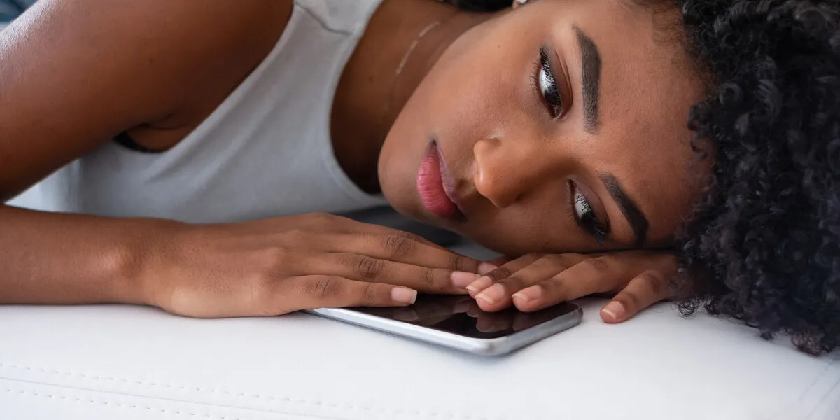 sad woman lying on the couch at home feeling bad