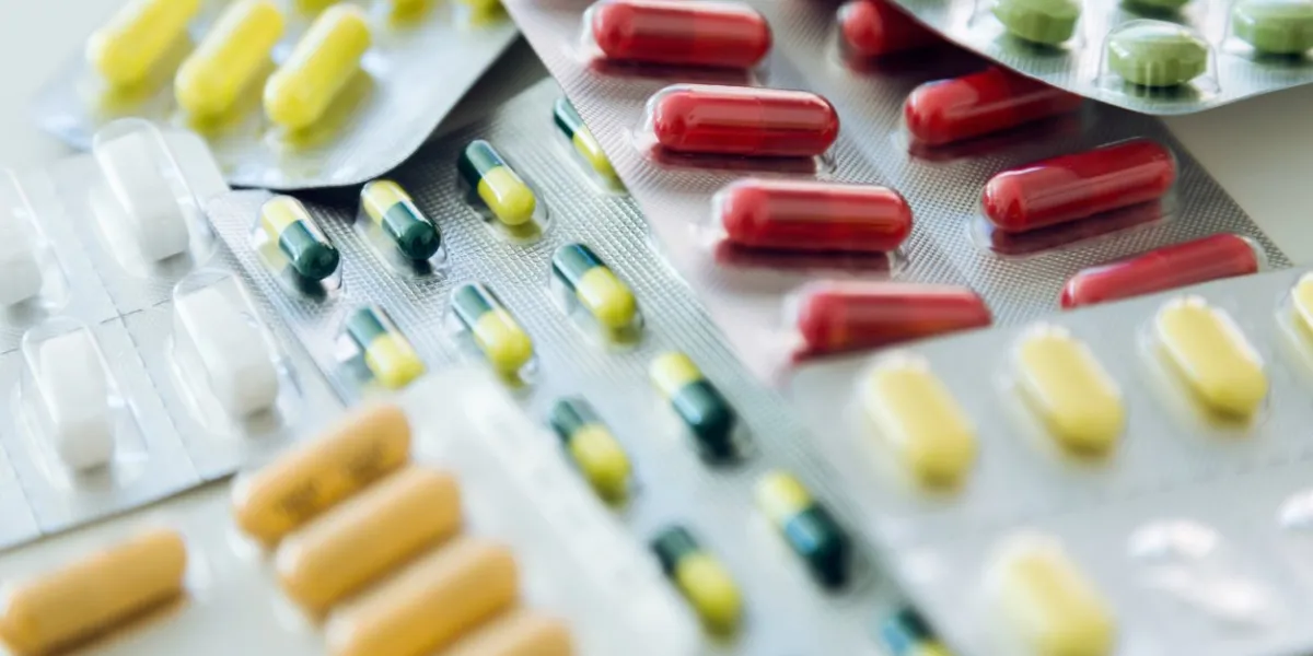 portrait of assorted pharmaceutical medicine pills, tablets and capsules on the table