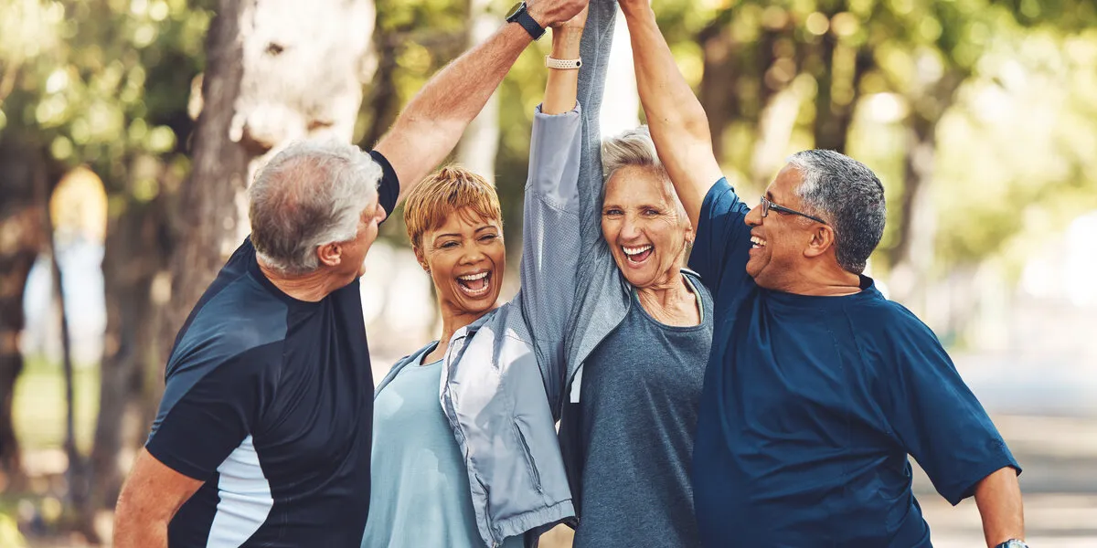 happy, senior or people high five for fitness training goals, workout target or exercise achievement in nature healthy, partnership or excited elderly men and women in celebration of group teamwork