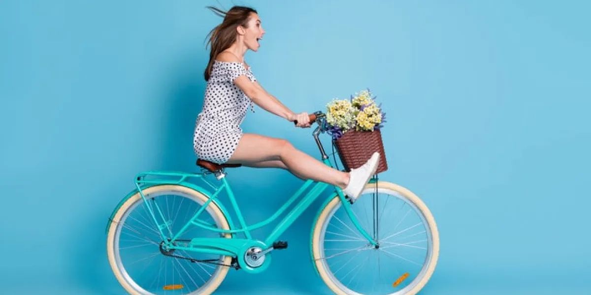 full length profile photo of crazy girl drive bike raise legs wear dotted short dress footwear isolated blue color background