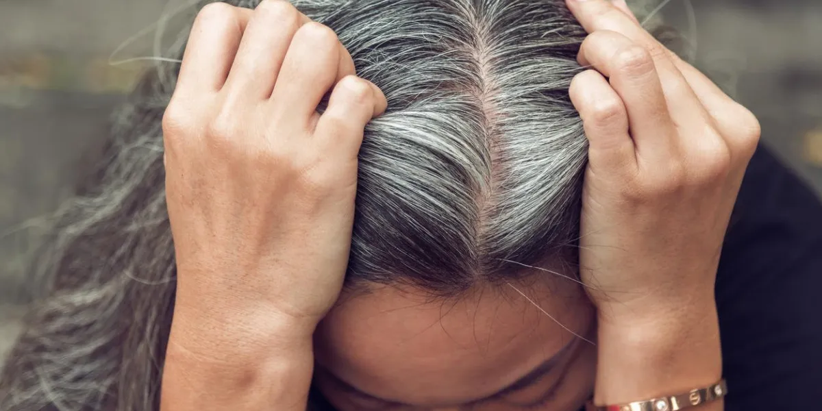 closeup sad asian young beautiful woman and gray hair with worried stressed face expression looking down