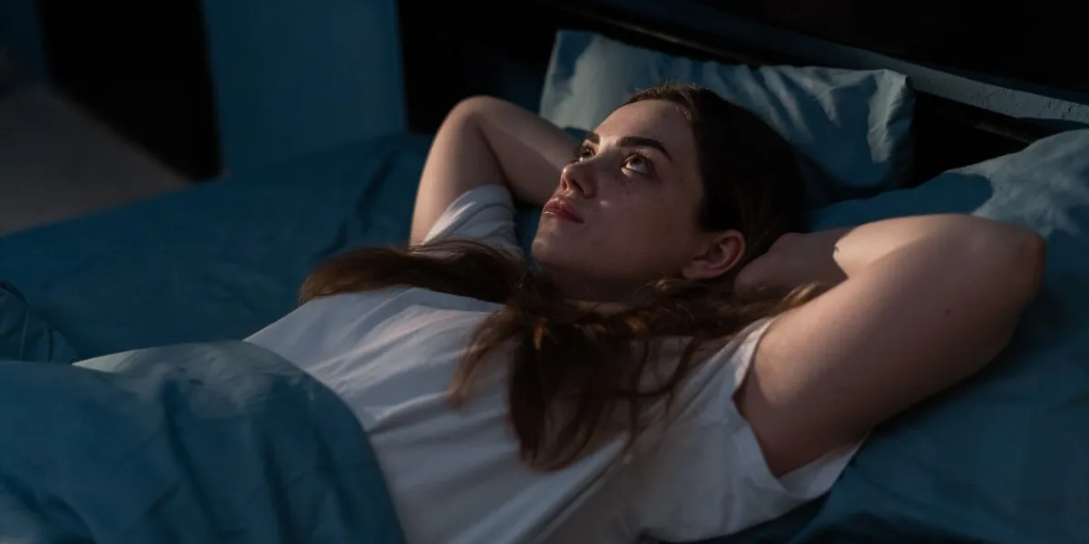 sleep disorder, insomnia concept young woman lying on the bed awake at late night can not sleep