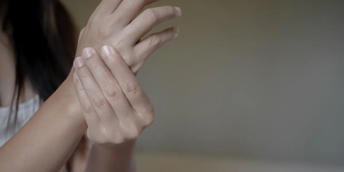 closeup young woman with painful hand health care concept