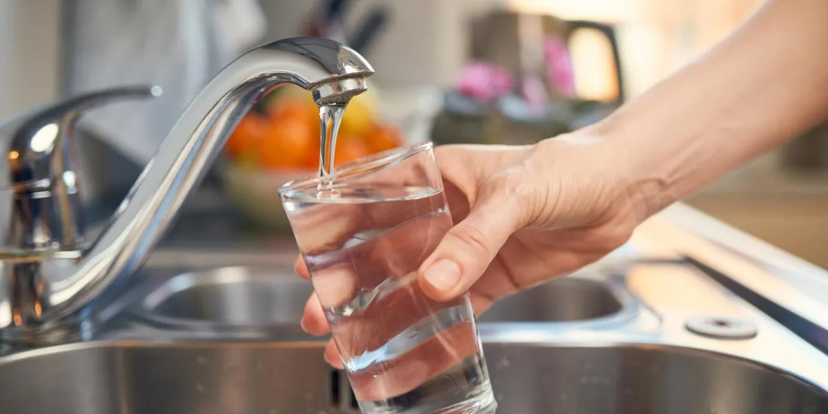 pouring fresh tap water into a glass