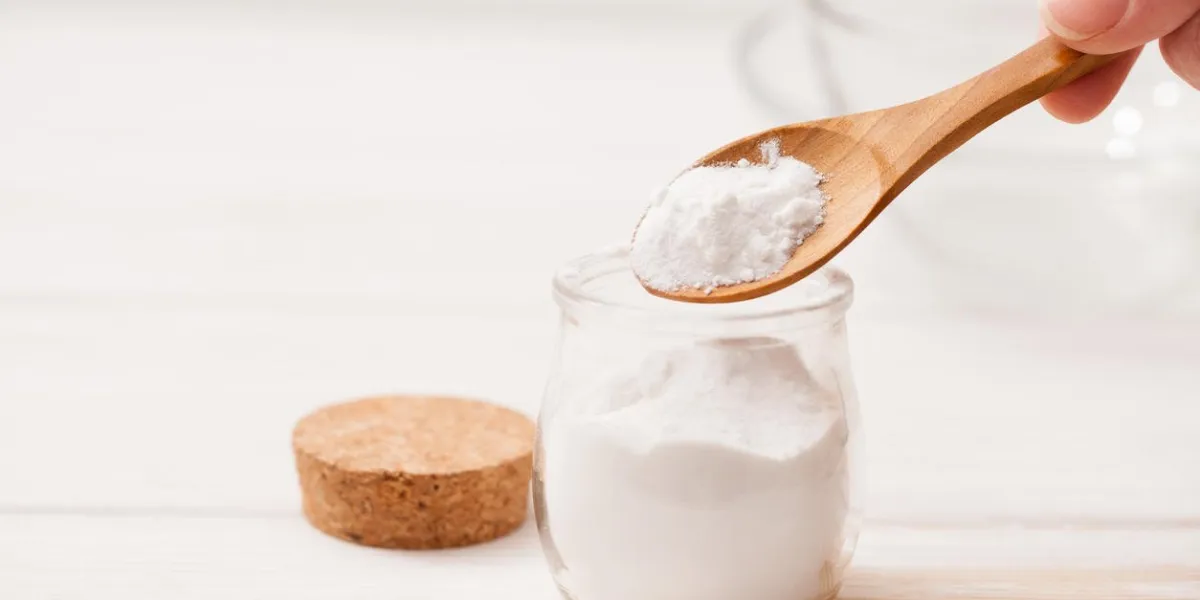 sea salt, starch in the jar and wooden spoon for recipes of cosmetics at home on a white wooden background
