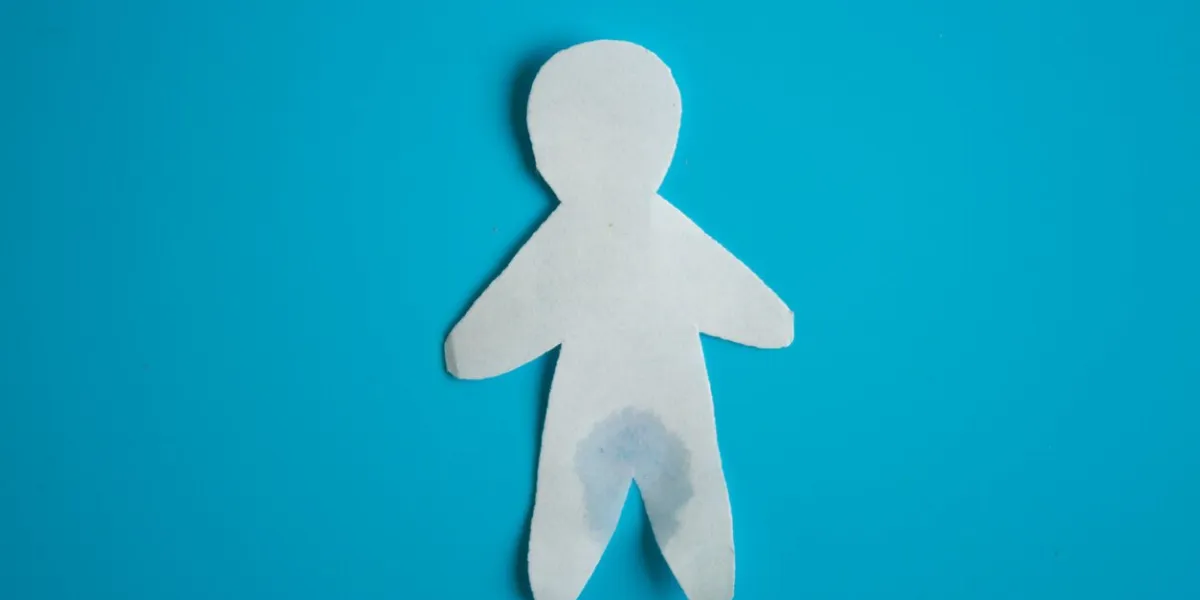 urinary incontinence concept wet paper person blue background