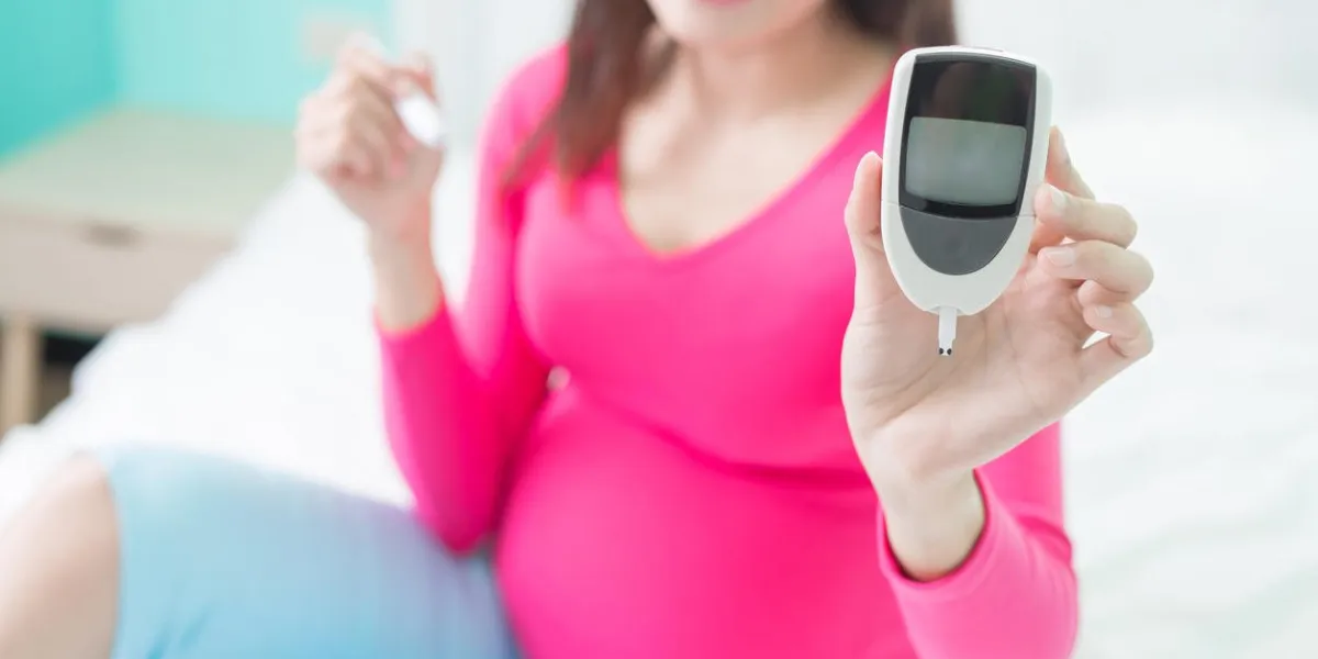 beauty pregnancy woman with glucometer on the bed