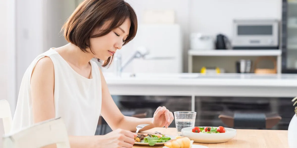 young attractive asian woman who eats,no appetite