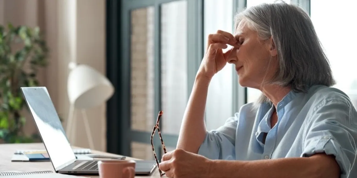 tired old senior business woman taking off glasses suffers from eyestrain, stress, headache, fatigue after computer use work in office exhausted sick mature lady feels eye strain problem at workplace