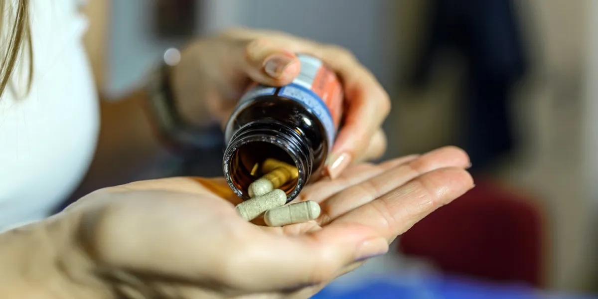 teen feels ill taking medicine, depressed girl about to take antidepressant pill, emergency contraceptive, painkiller for painful periods