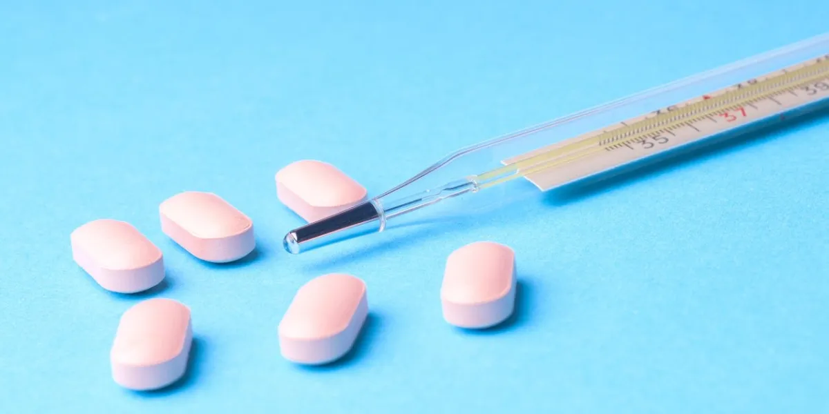 many pills and tablets isolated on light blue background