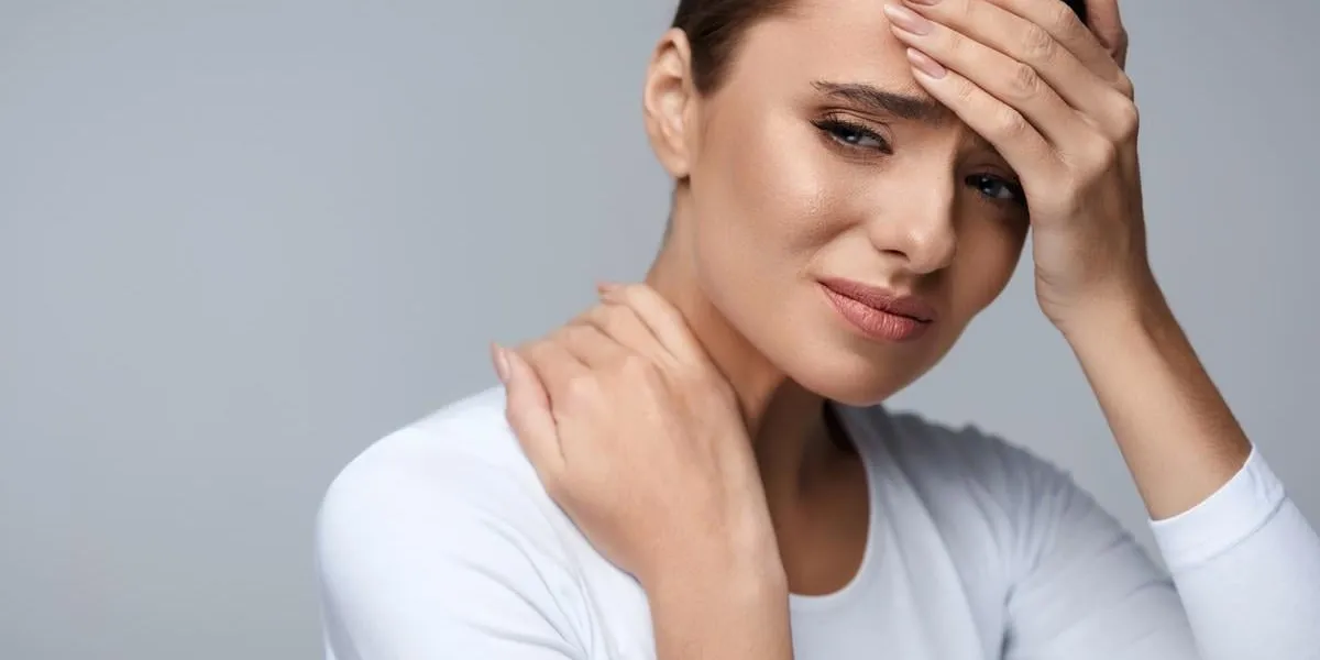 pain and fever beautiful young woman feeling sick and tired female having headache and high temperature girl suffering from painful body aches, neck pain, holding hand on forehead high resolution