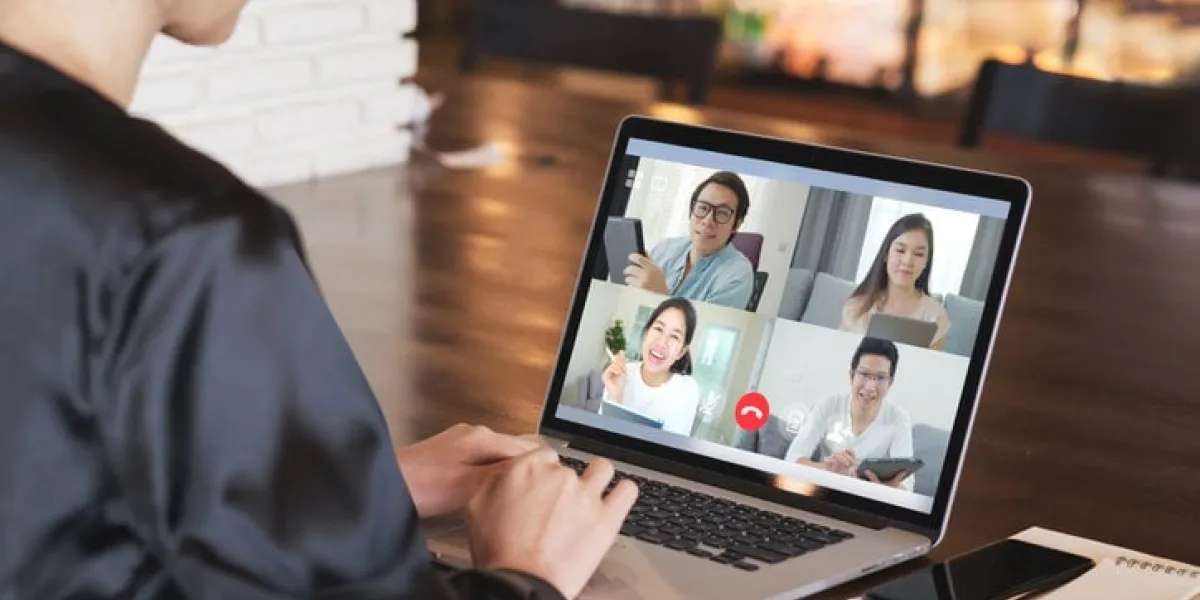 back view of business woman talking about sale report in video conference asian team using laptop and tablet online meeting in video callworking from home, working remotely and social isolation