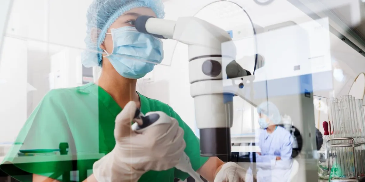 asian scientist using microscope in the laboratory