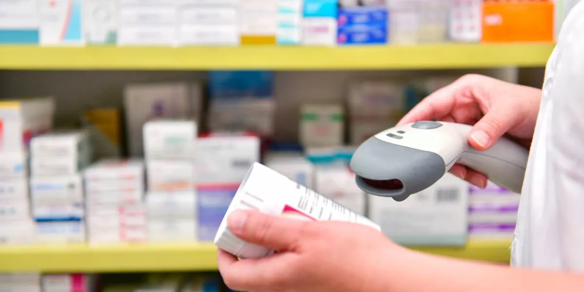 pharmacist scanning barcode of medicine drug in a pharmacy drugstore