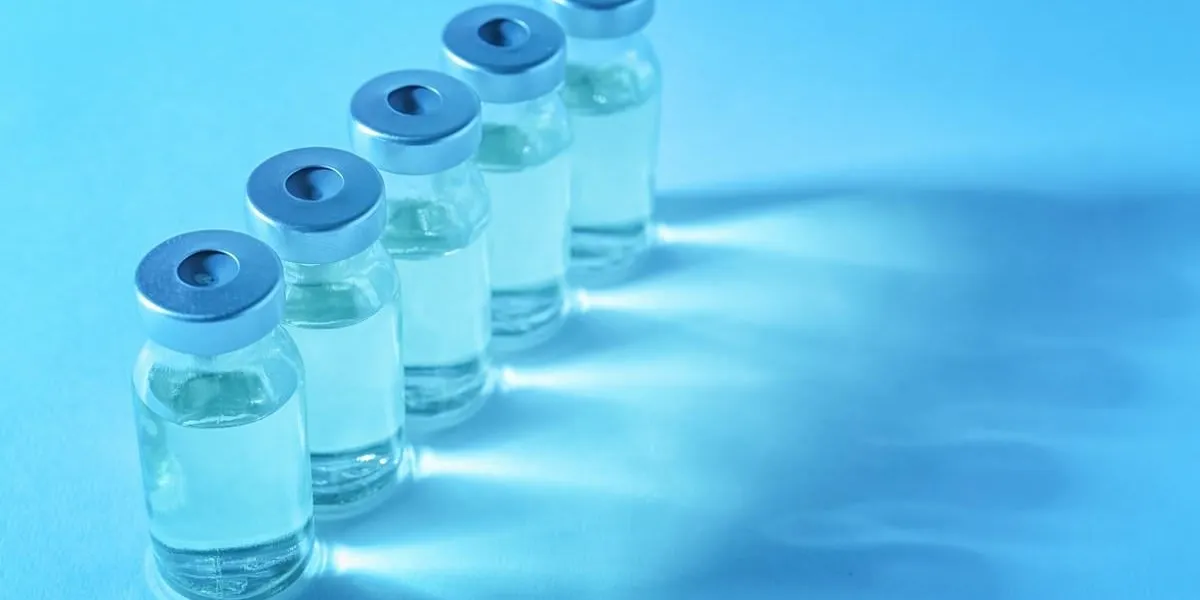 medical ampules on colour background vaccination concept