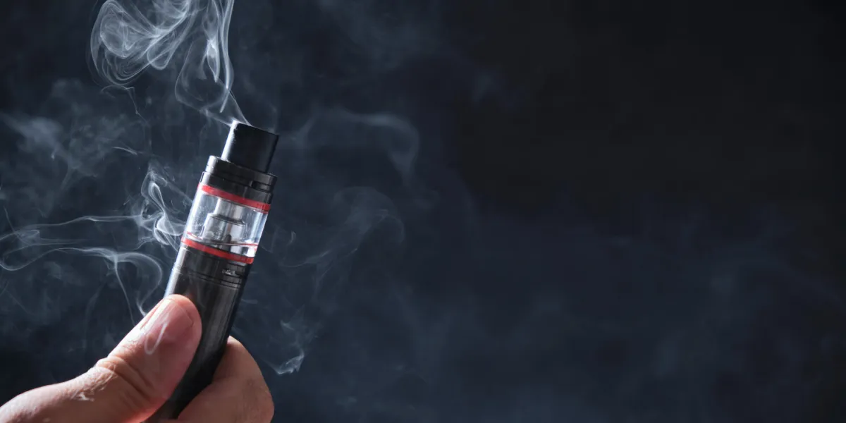 electronic cogarette vape on a dark background with steam