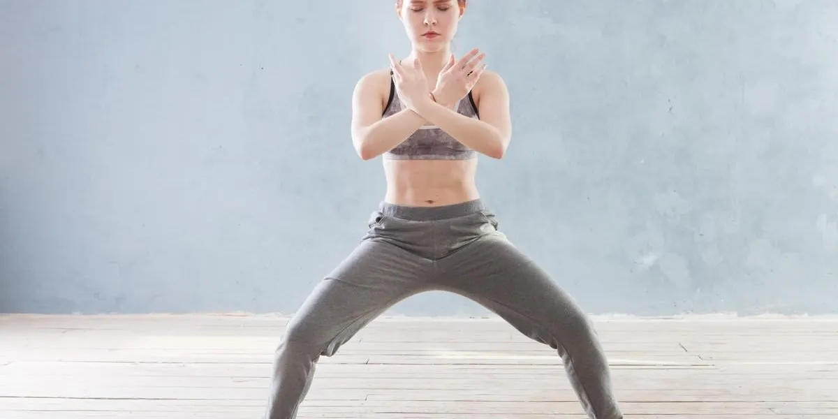 young woman praticing tai chi chuan in the gym chinese management skill qi's energy