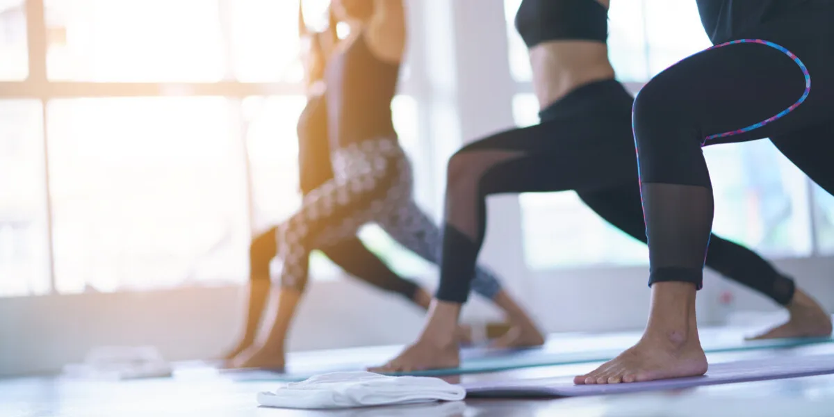 women exercising in fitness studio yoga classes
