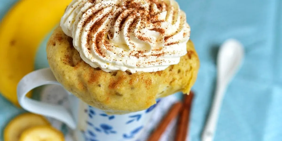 banana mug cake decorated with whipped cream