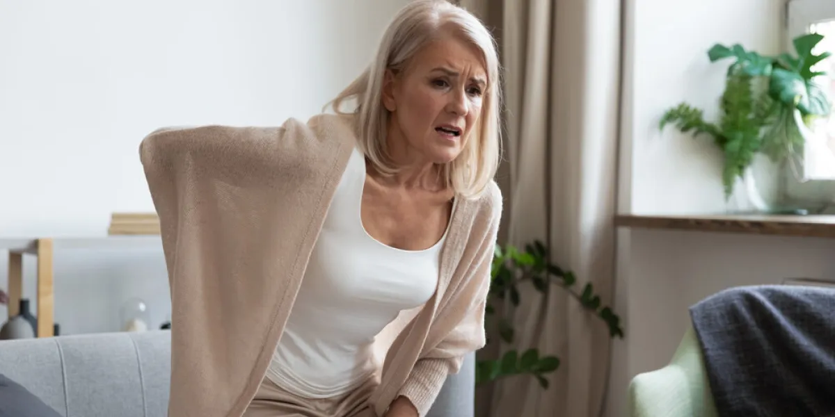 worried upset middle aged mature woman feel hurt sudden back ache touch sore spine at home alone, tired mature senior grandmother having lower lumbago backache injury spinal pain, backpain concept