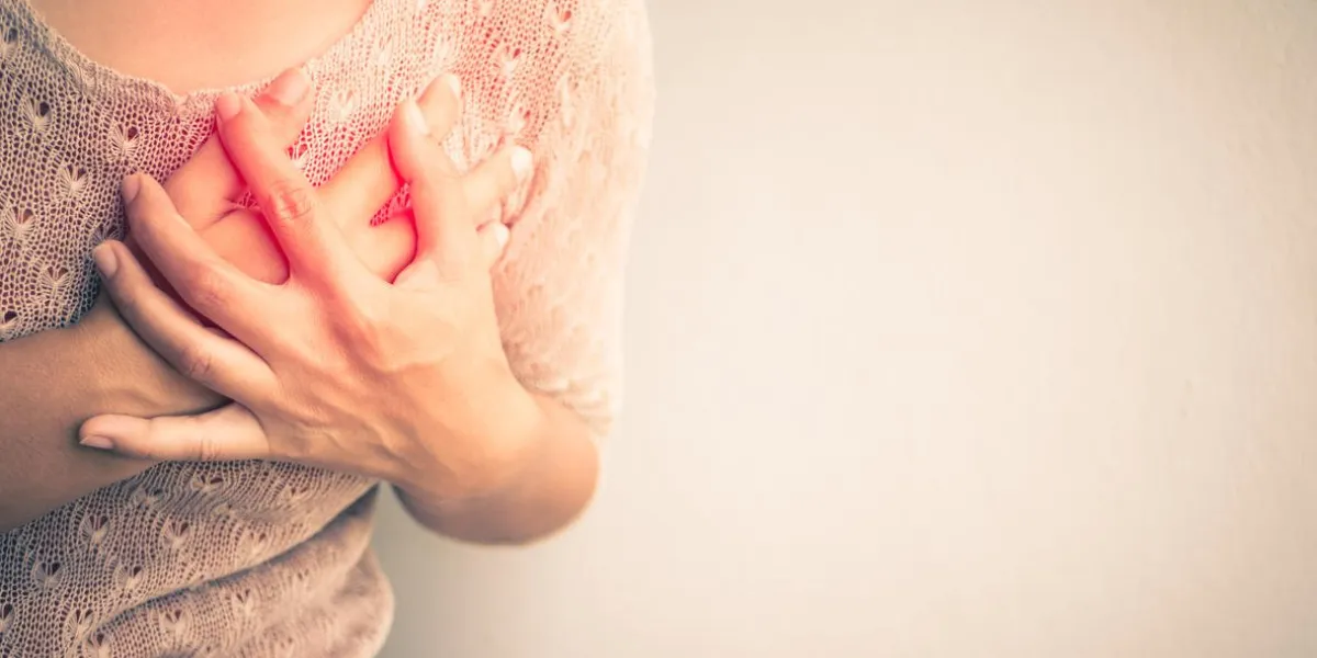 woman having a pain in the heart attact medical and health care concept
