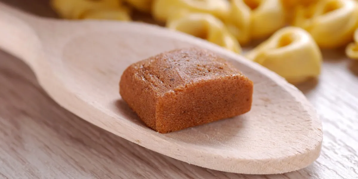 bouillon cube in wooden spoon