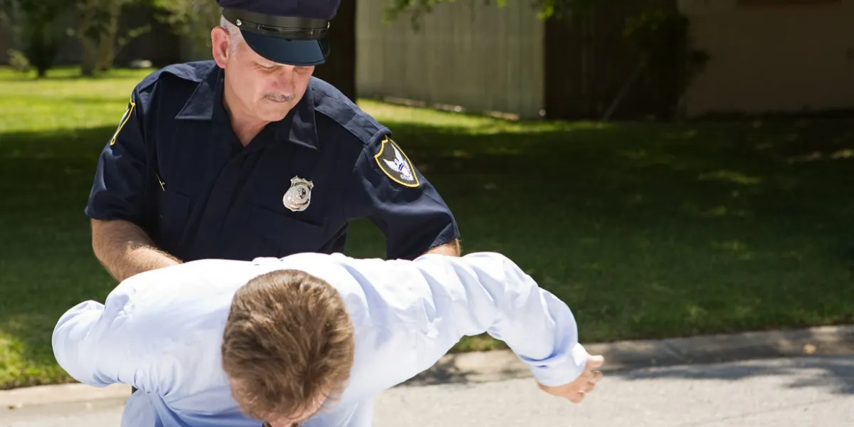 policeman placing a drunk driver under arrest room for text