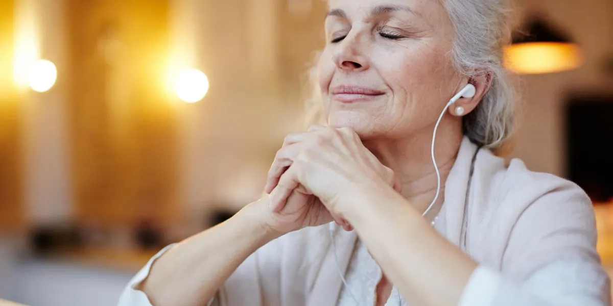 mature woman with earphones listening to music