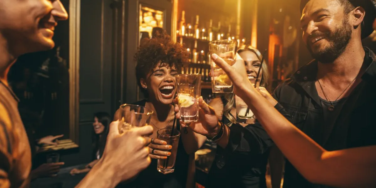 shot of young men and women enjoying a party group of friends having drinks at nightclub