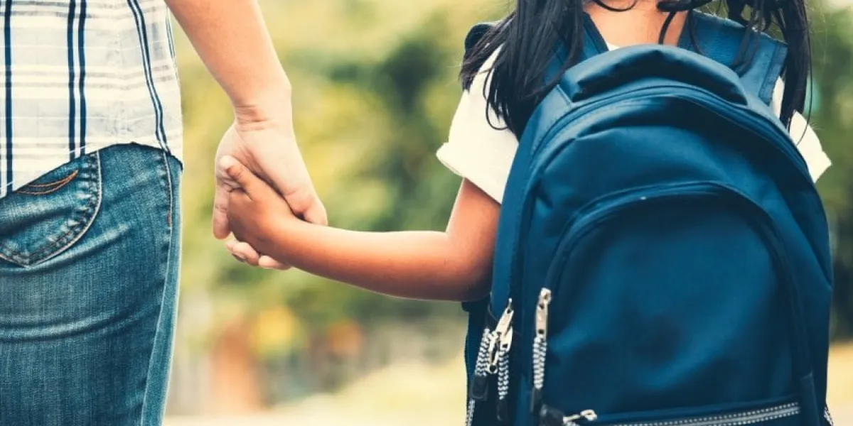 back to school cute asian pupil girl with backpack holding her mother hand and going to school in vintage color tone
