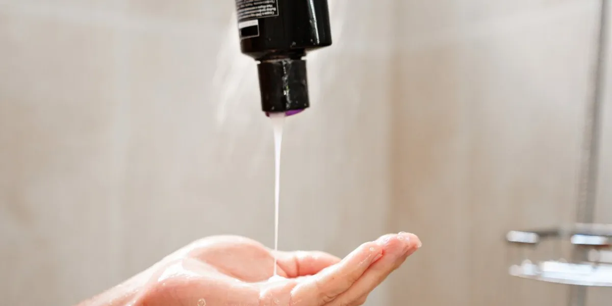 shampoo is poured from the bottle into the palm of the hand cosmetics for shower and body care