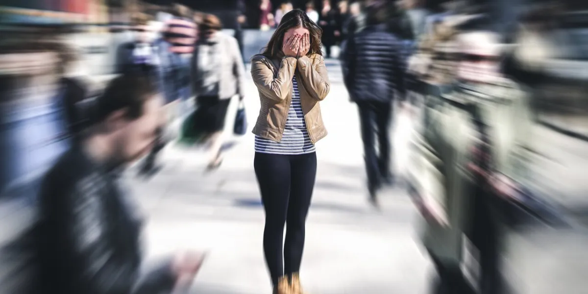 panic attack in public place woman having panic disorder in city psychology, solitude, fear or mental health problems concept depressed sad person surrounded by people walking in busy street