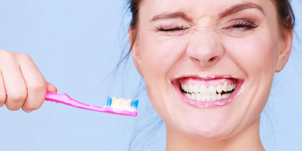woman brushing cleaning teeth girl with toothbrush oral hygiene blue background