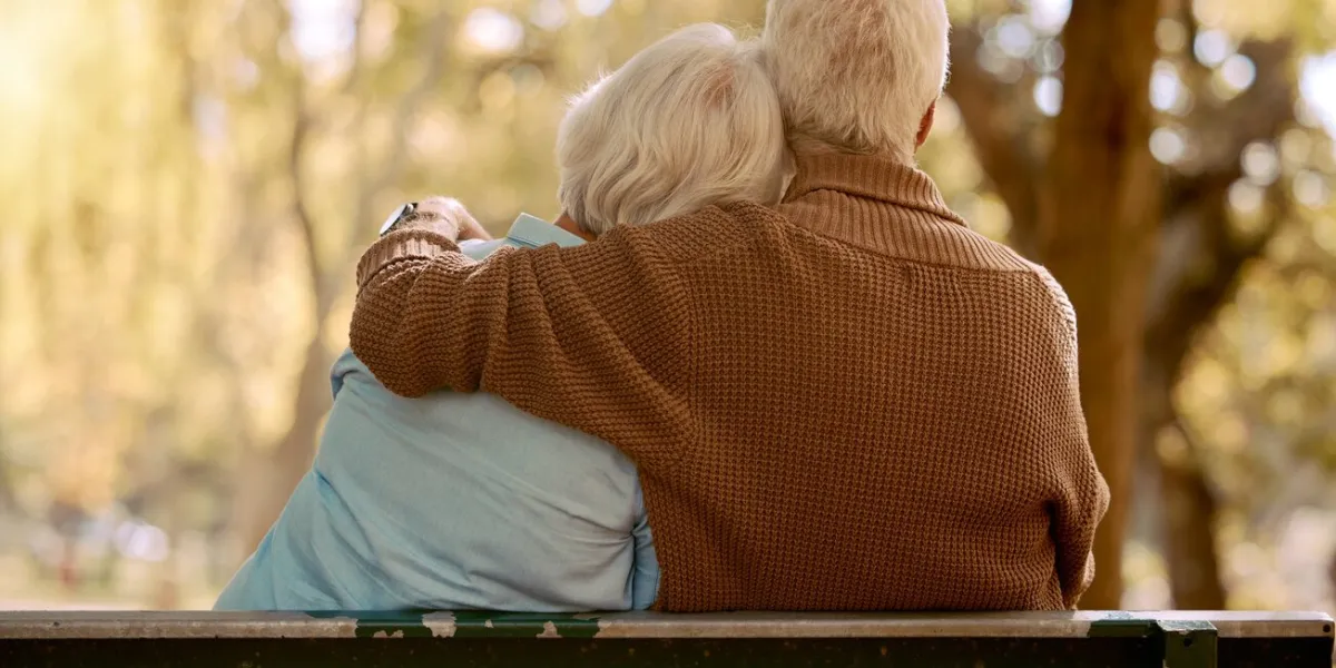 relax, hug and love with old couple in park for happiness, marriage and calm peace, nature and retirement with man embracing woman on bench for affectionate, bonding and wellness date together
