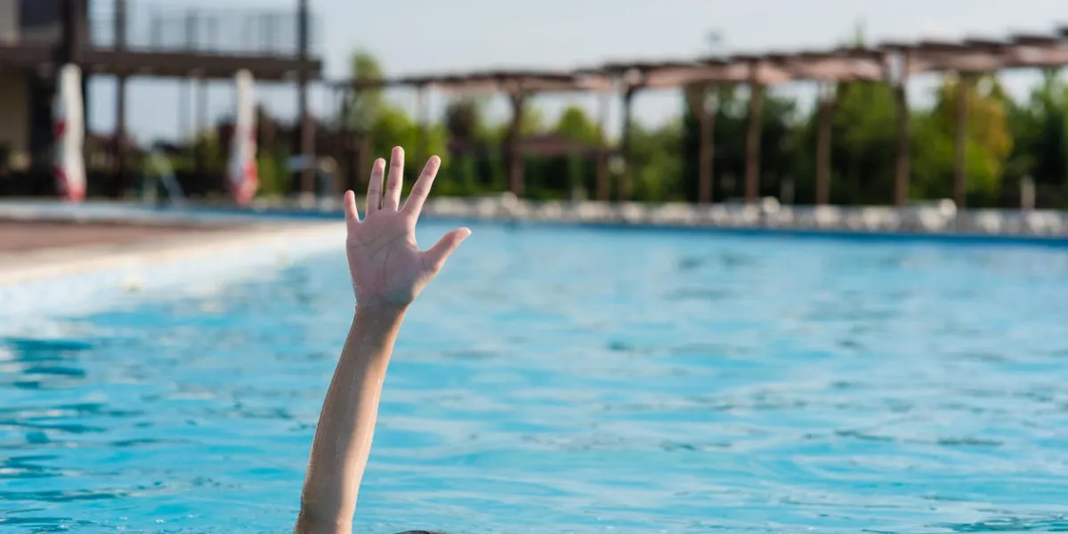 hand of a drowning person in a swimming pool concept photo