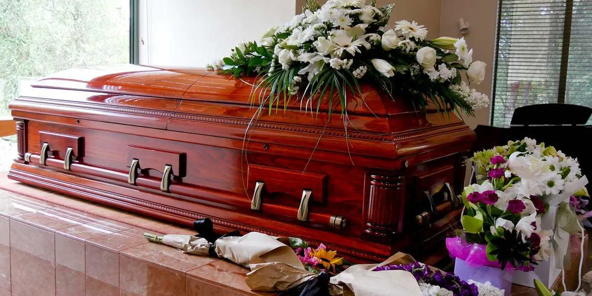 closeup shot of a colorful casket in a hearse or chapel before funeral or burial at cemetery
