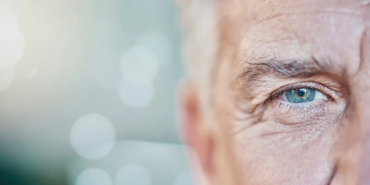 retina, vision and mockup with blue eye of old man for focus, optometry and healthcare iris, human and awareness with senior male and pupil for sight, natural and ophthalmology on bokeh background