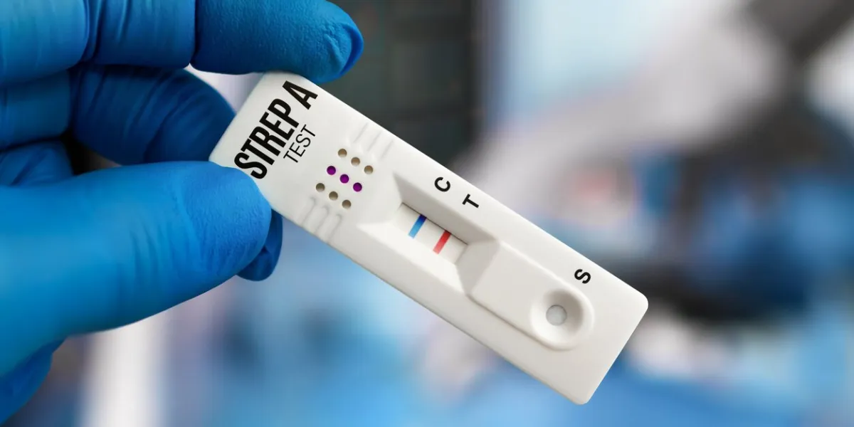 physician with test rapid positive to illness streptococcus group a doctor or pediatrician holding test cassette for strep a disease diagnostic