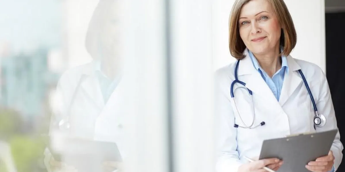 portrait copié-espacé d'un médecin généraliste amical tenant un dossier médical