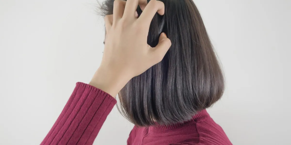 woman scratching her head