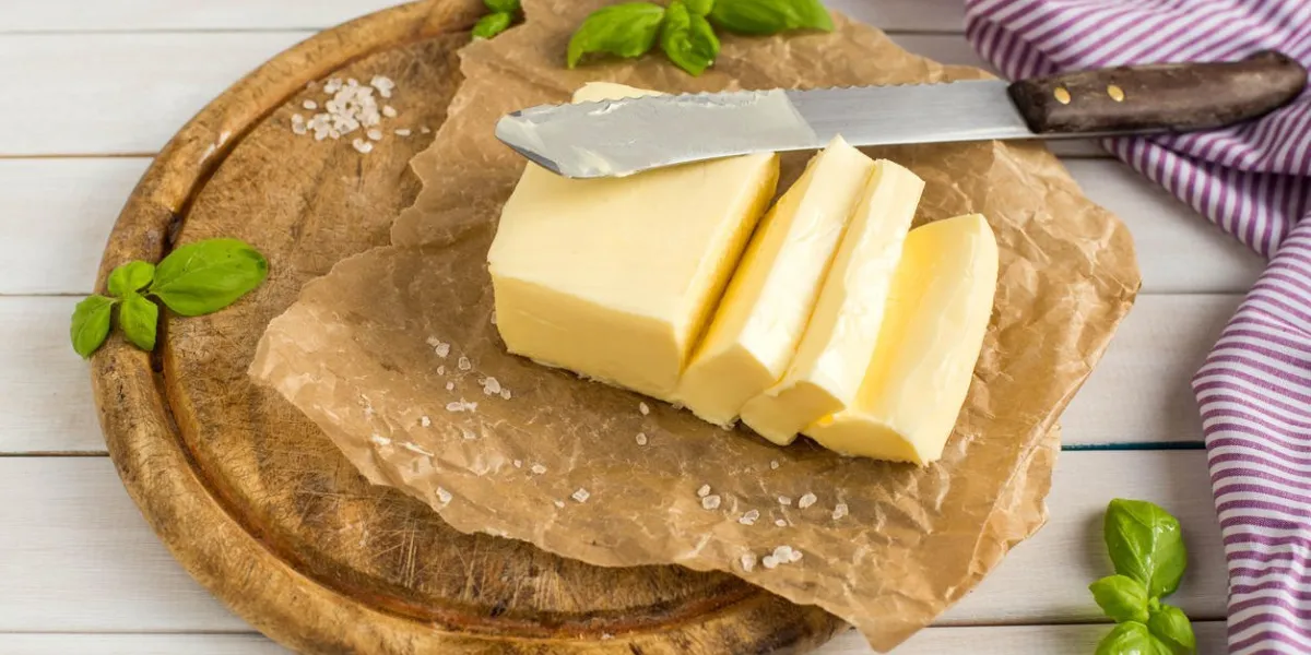 butter on the wooden plate dairy products close up