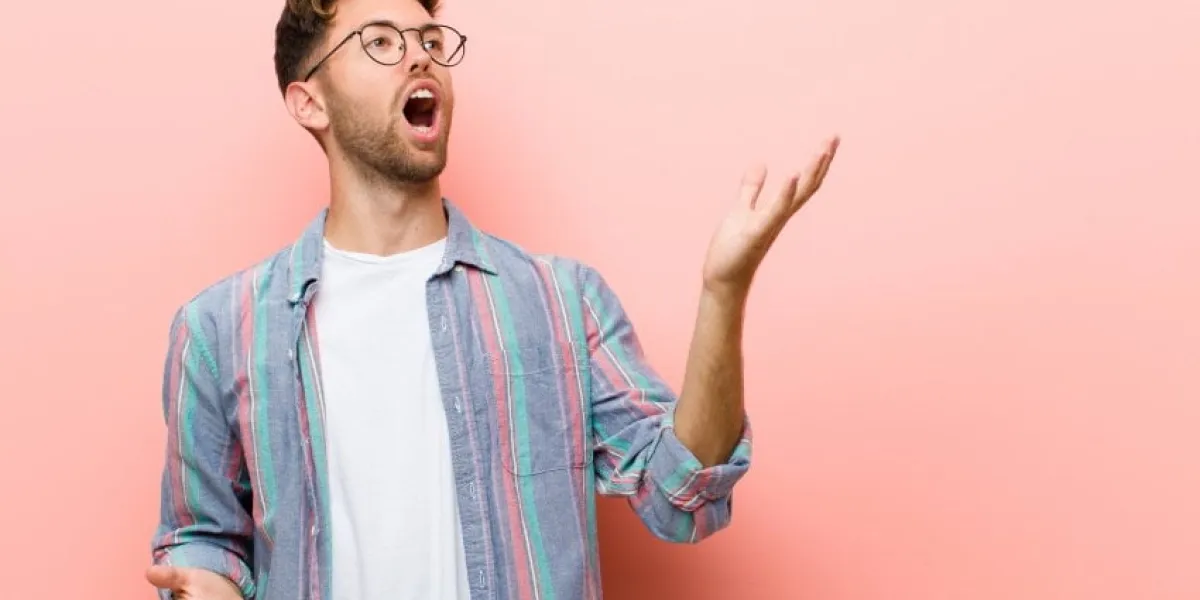 young man performing opera or singing at a concert or show, feeling romantic, artistic and passionate against pink background