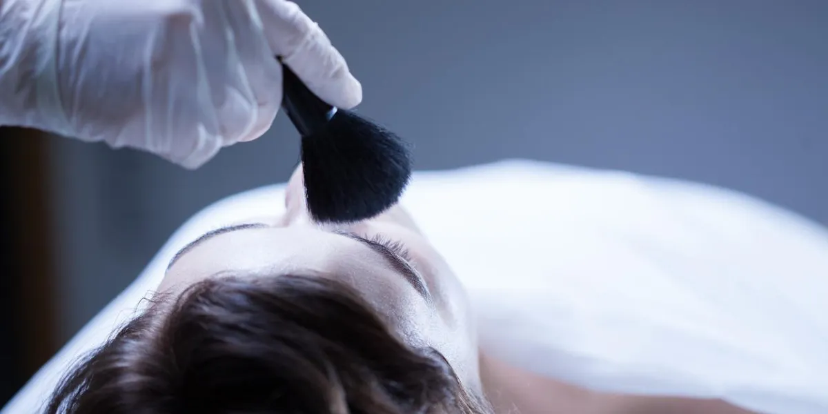 worker of funeral service making posthumous cosmetics