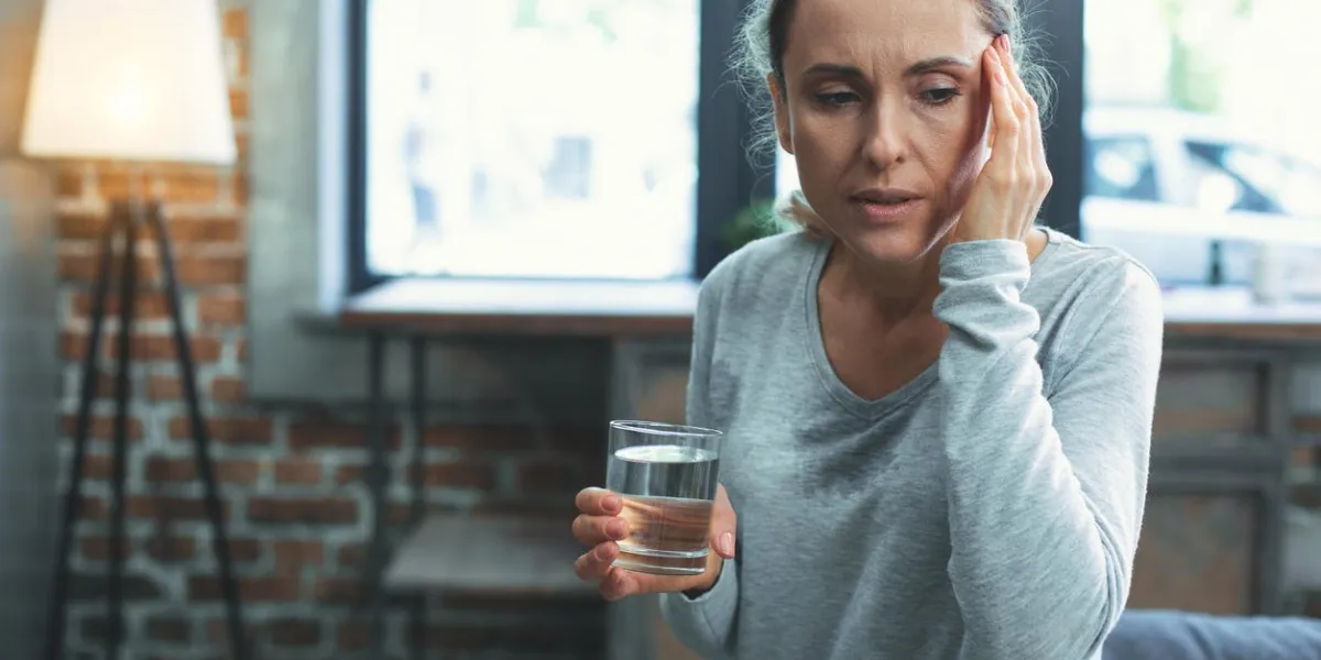 shortness of breath unhappy mature woman sweating and touching head