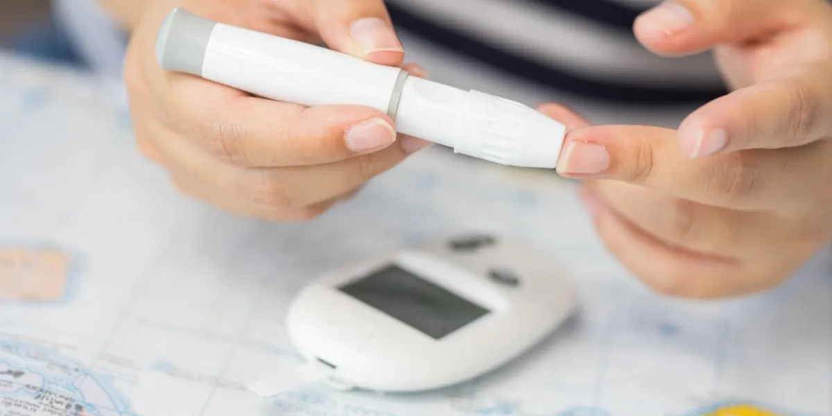 close up of asian woman hands using lancet on finger to check blood sugar level by glucose meter, healthcare medical and check up, medicine, diabetes, glycemia, health care and people concept