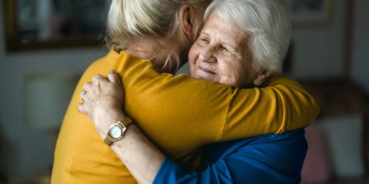 woman hugging her elderly mother